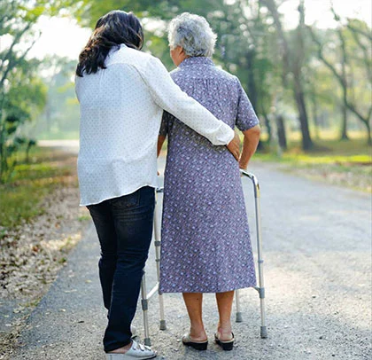 Assisting an elderly woman to take a walk outside